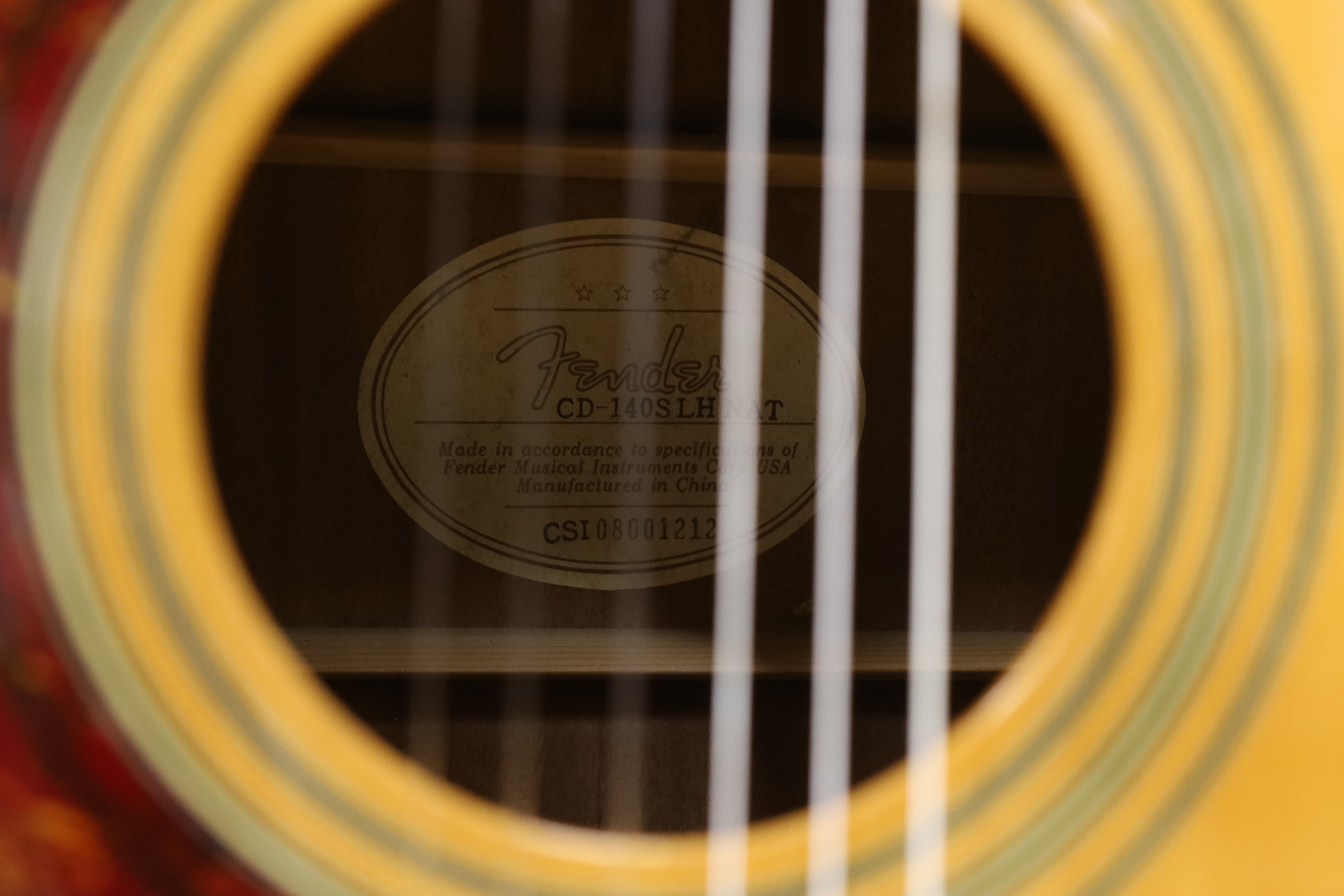 A Fender acoustic left handed guitar, in a hard case